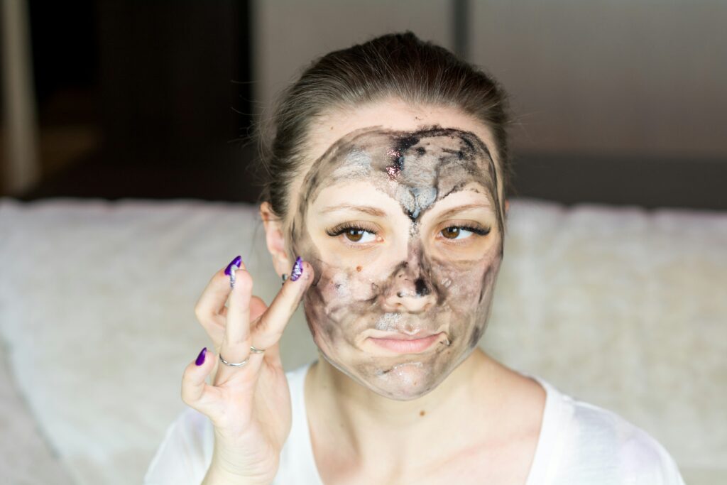 Woman with messy face mask application, highlighting mistakes in DIY natural skincare routines