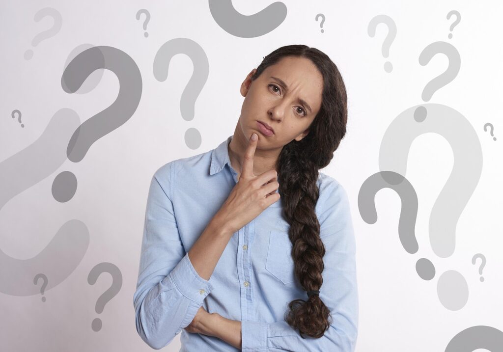 Woman looking at her reflection, concerned about skincare choices – natural beauty NZ