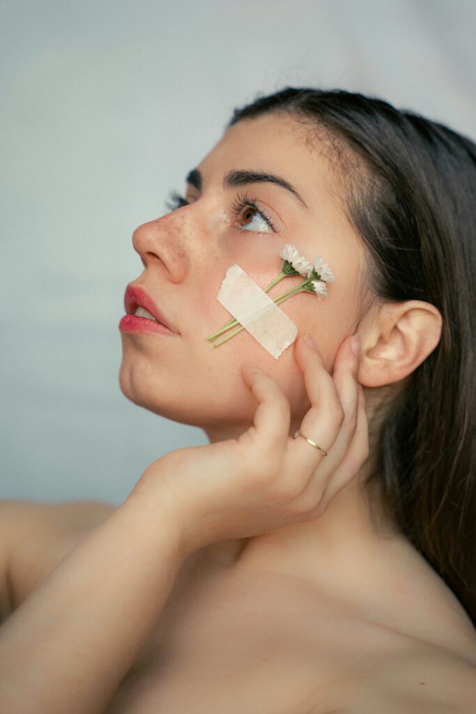 Woman gently touching face — representing skincare sensitivity and over-exfoliation